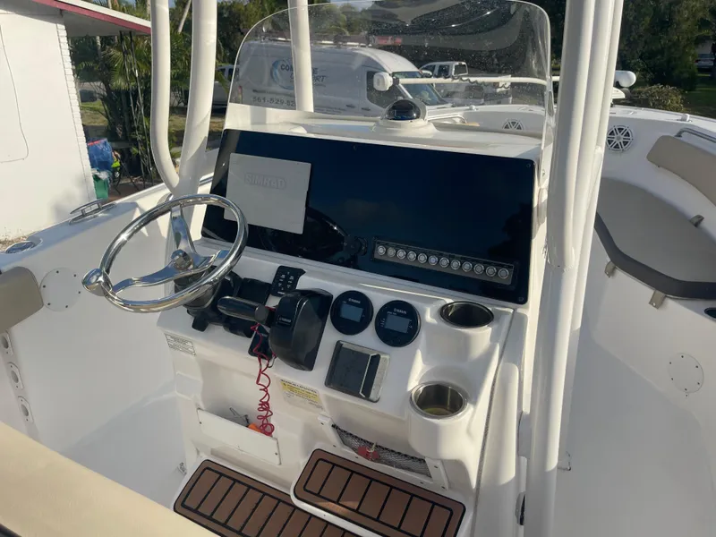 Slide: The Image of 2022 Tidewater Adventure boat dashboard with steering wheel and navigation controls. - 9
