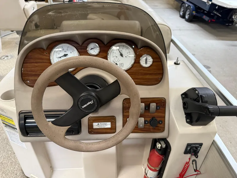 Slide: The Image of Steering console of a 2004 Premier 250 Legend Deluxe RE boat with gauges and controls. - 6