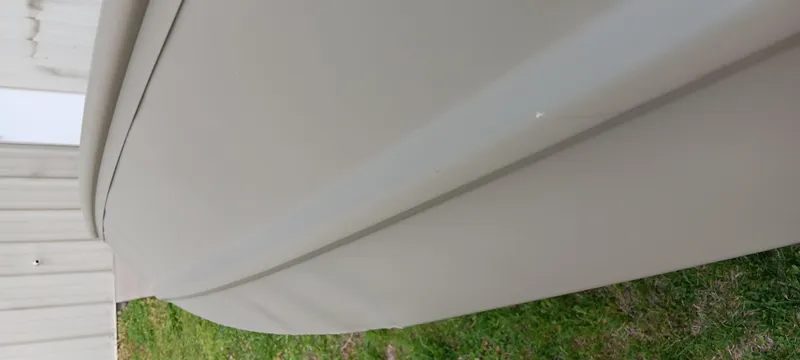 Slide: The Image of 2024 Tracker Grizzly 1236 Jon boat hull on grass, close-up view. - 8