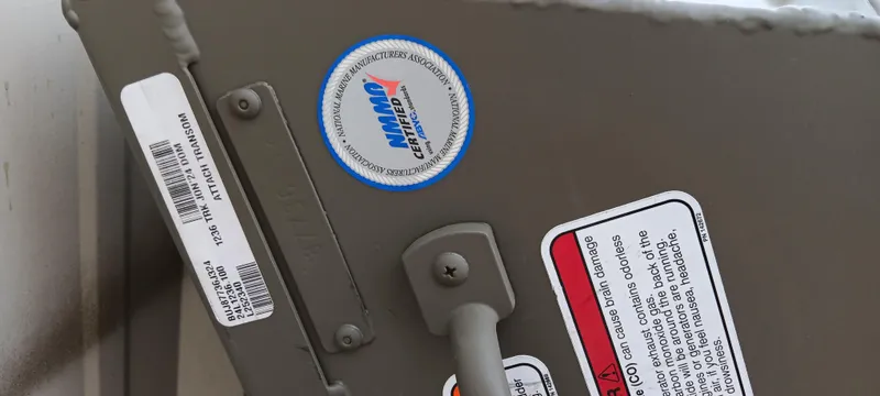 Slide: The Image of 2024 Tracker Grizzly 1236 Jon boat with safety and certification labels. - 9