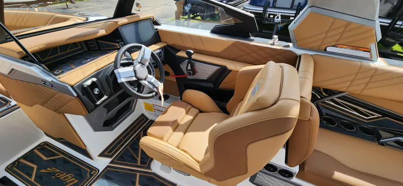 Slide: The Image of 2025 Tigé Ultre ZX boat interior with luxurious tan leather seating and modern dashboard. - 12