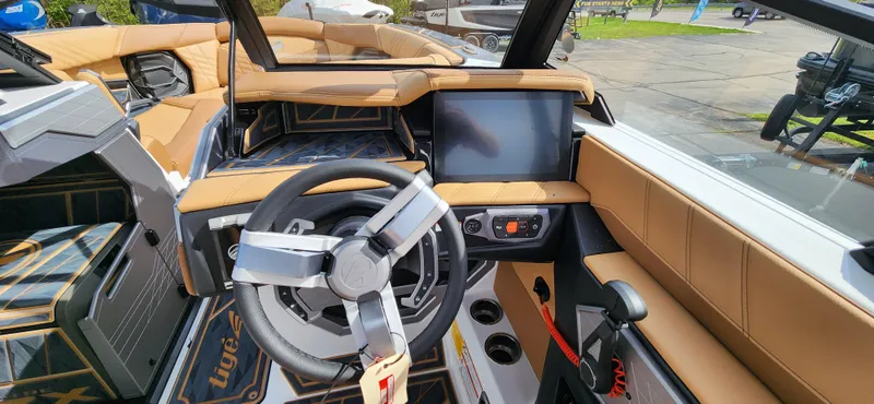 Slide: The Image of 2025 Tigé Ultre ZX boat interior with modern dashboard and steering wheel. - 13
