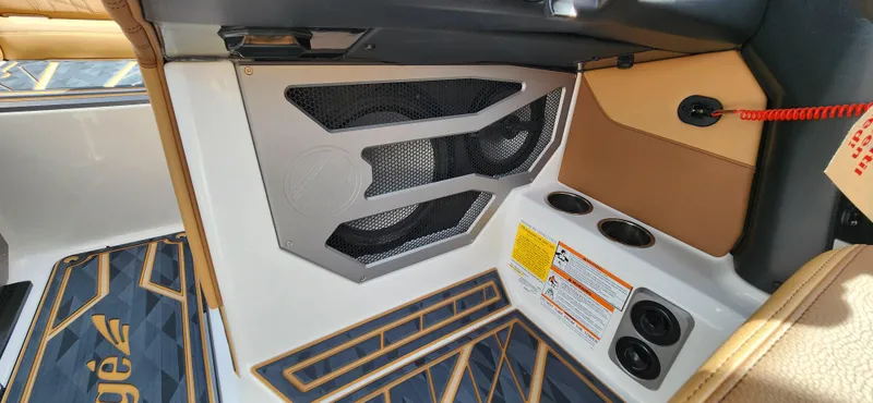 Slide: The Image of Interior of 2025 Tigé Ultre ZX boat featuring speaker system and cup holders. - 14