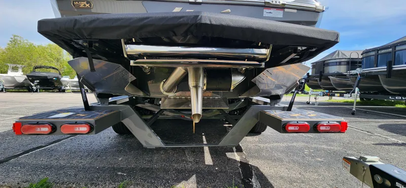 Slide: The Image of Rear view of 2025 Tigé Ultre ZX boat on trailer, showcasing exhaust and propeller. - 6