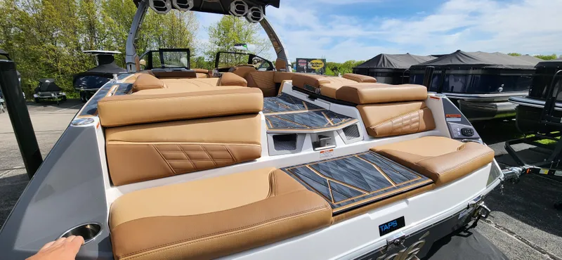 Slide: The Image of 2025 Tigé Ultre ZX boat with luxurious tan seating and sleek design. - 7