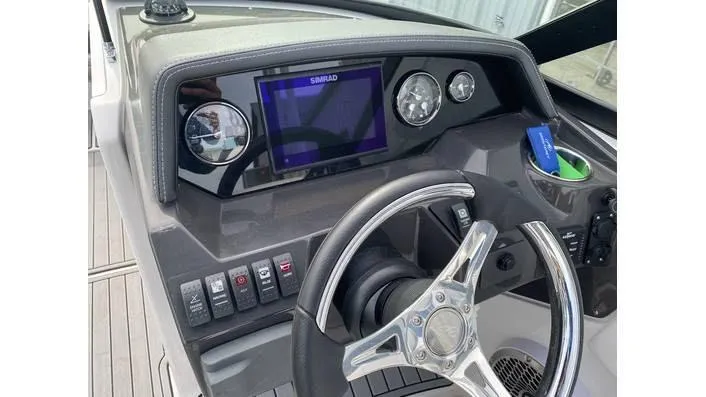 Slide: The Image of 2024 Monterey M-65 boat dashboard with steering wheel and digital display. - 5