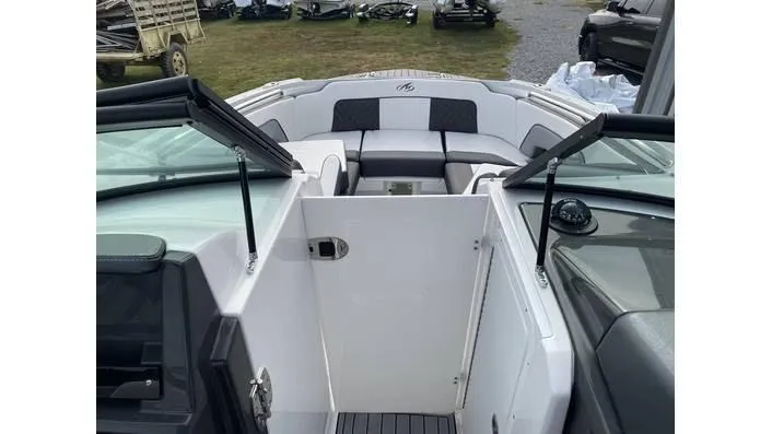 Slide: The Image of 2024 Monterey M-65 boat interior with open windshield and seating area. - 6