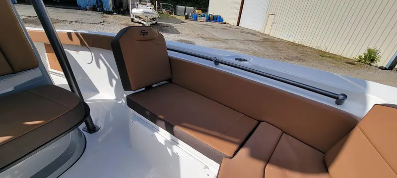 Slide: The Image of 2025 Sea Pro 225 Sandbar boat interior with brown seating and white deck. - 10