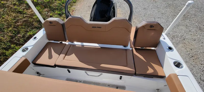 Slide: The Image of 2025 Sea Pro 225 Sandbar boat interior with tan seating and cup holders. - 11