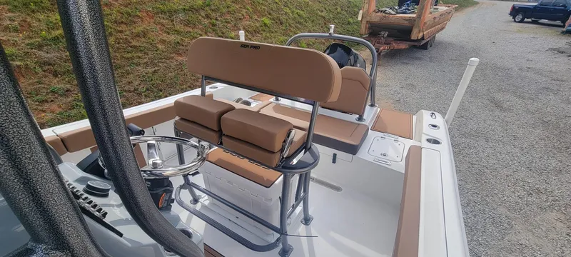 Slide: The Image of 2025 Sea Pro 225 Sandbar boat interior with tan seating and steering wheel. - 13