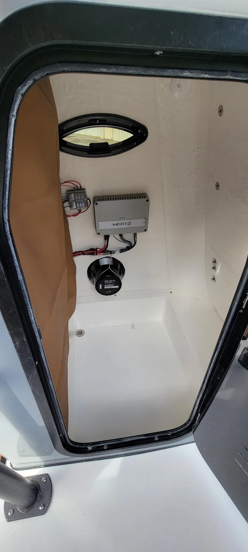Slide: The Image of 2025 Sea Pro 225 Sandbar boat storage compartment with electrical components. - 16