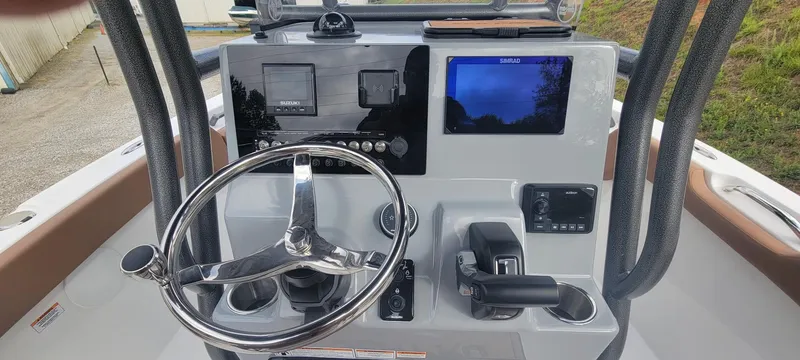 Slide: The Image of 2025 Sea Pro 225 Sandbar boat dashboard with steering wheel and electronic controls. - 5