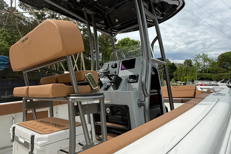 Slide: The Image of 2025 Sea Pro 225 Sandbar boat interior with tan seating and modern console. - 6