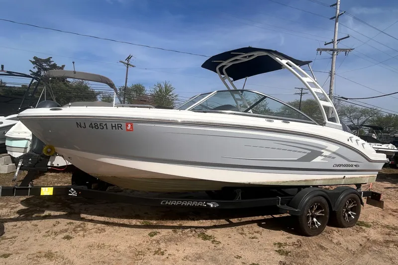 The Image of 2021 Chaparral SSI boat on trailer, parked outdoors, side view. - 1