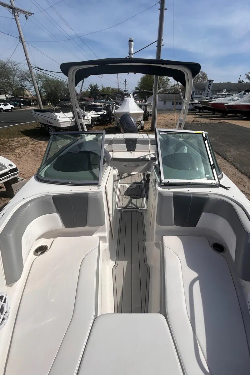 Slide: The Image of 2021 Chaparral SSI boat with open deck, sleek design, and modern features. - 5