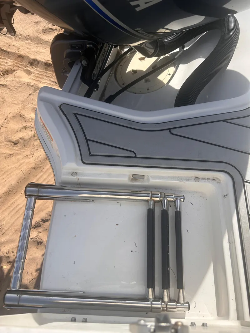 Slide: The Image of 2021 Chaparral SSI boat with a folded swim ladder on the deck. - 9