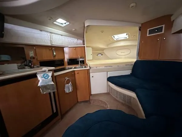 Slide: The Image of Interior of 2002 Bayliner 3055 Ciera boat with kitchen and seating area. - 12
