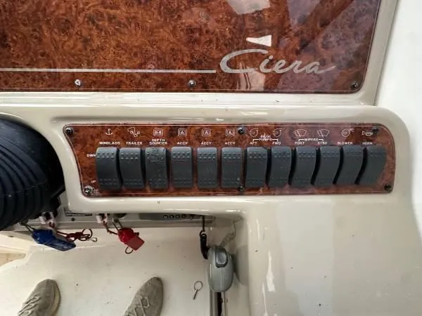 Slide: The Image of Control panel of a 2002 Bayliner 3055 Ciera boat with labeled switches. - 14