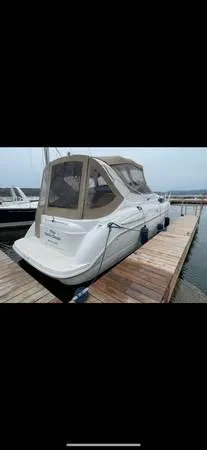 Slide: The Image of 2002 Bayliner 3055 Ciera docked at a marina, featuring a covered cabin. - 18