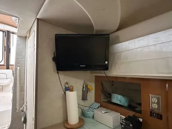 Slide: The Image of Interior of 2002 Bayliner 3055 Ciera with mounted TV and storage area. - 24
