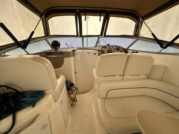 Slide: The Image of 2002 Bayliner 3055 Ciera boat interior with beige seating and helm. - 4