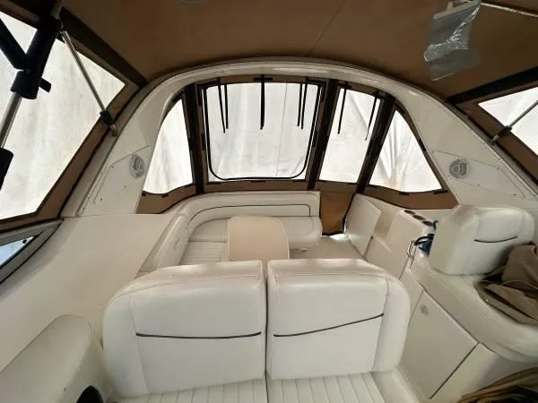 Slide: The Image of Interior of a 2002 Bayliner 3055 Ciera boat with white seating and brown accents. - 8