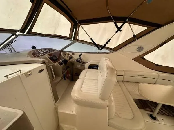 Slide: The Image of 2002 Bayliner 3055 Ciera boat interior with beige seating and dashboard. - 9