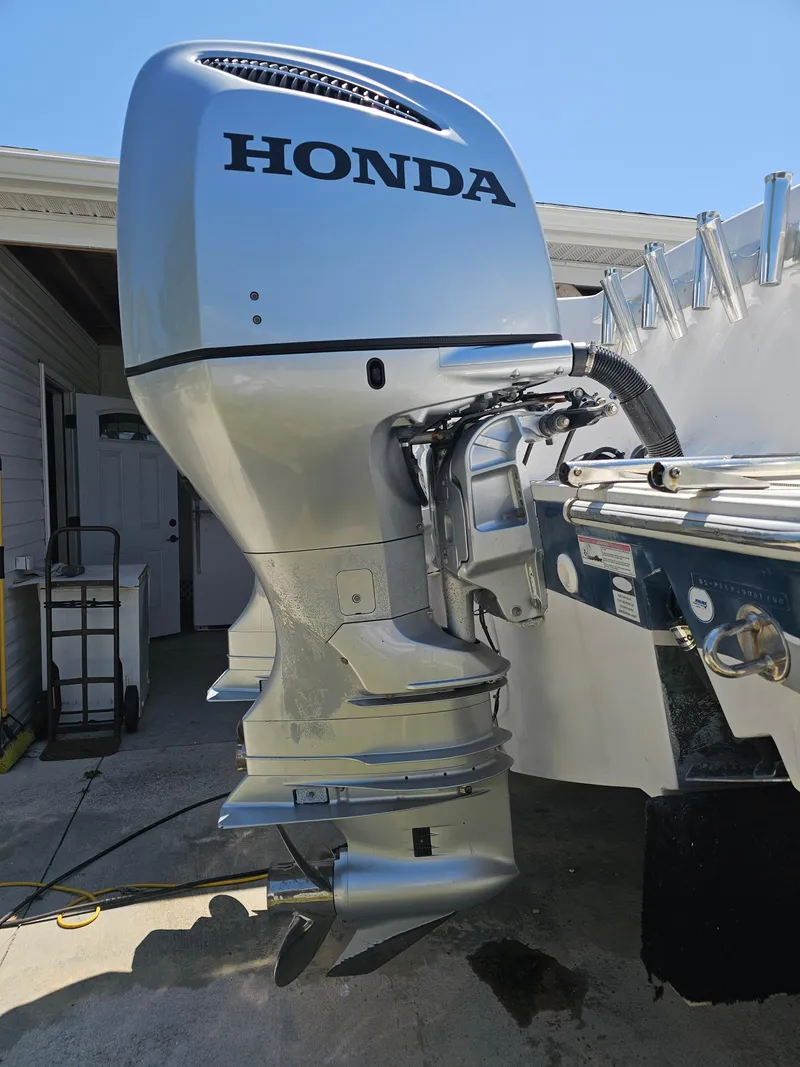 Slide: The Image of 2008 Pro-Line 29 Grande Sport with Honda outboard motor in a garage setting. - 21