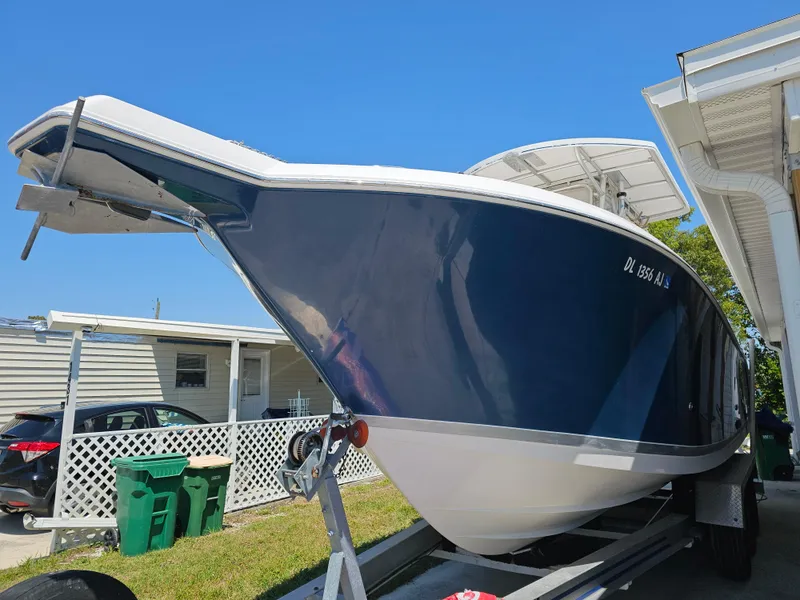 Slide: The Image of 2008 Pro-Line 29 Grande Sport boat on trailer, parked beside a house. - 25