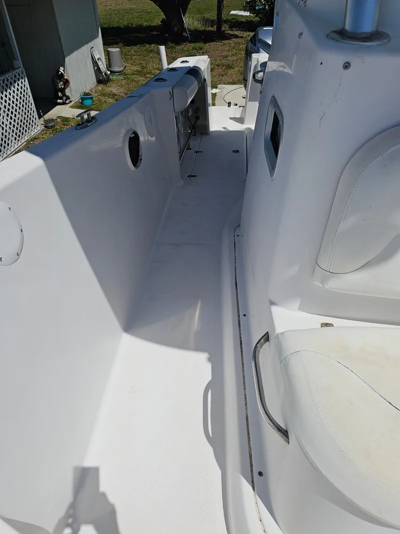 Slide: The Image of 2008 Pro-Line 29 Grande Sport boat interior, featuring white seating and clean deck. - 34