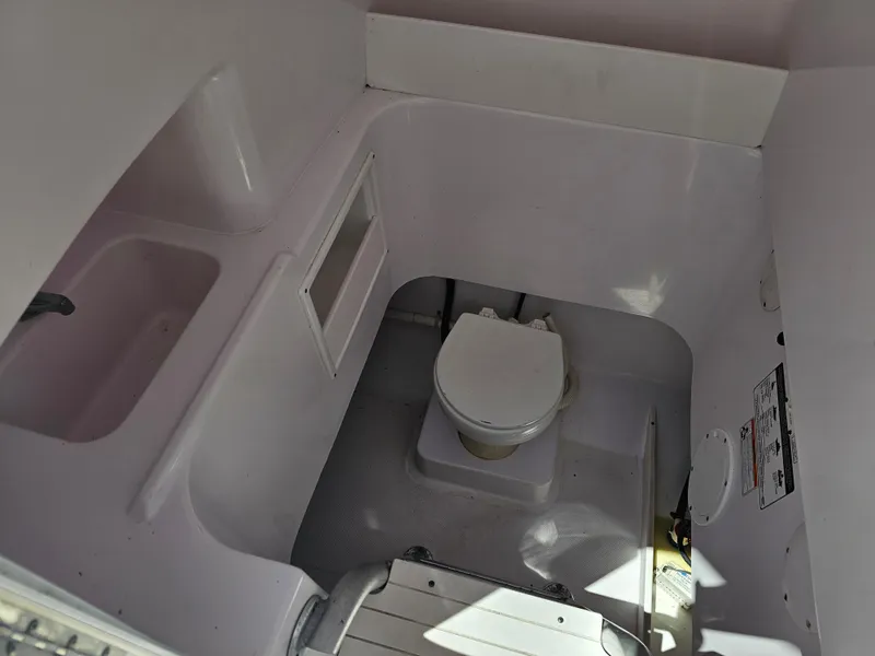 Slide: The Image of 2008 Pro-Line 29 Grande Sport boat interior with compact marine toilet. - 35