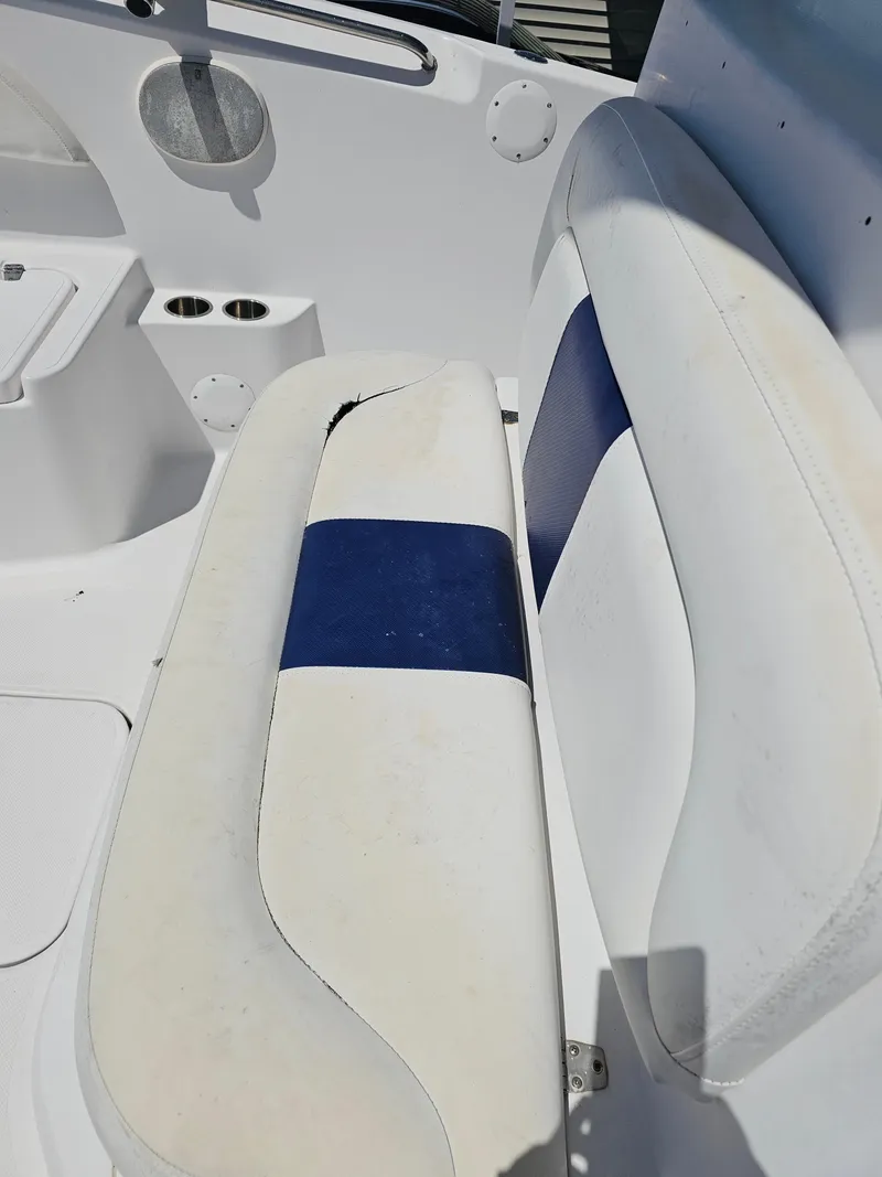 Slide: The Image of 2008 Pro-Line 29 Grande Sport boat interior with white and blue seating. - 36