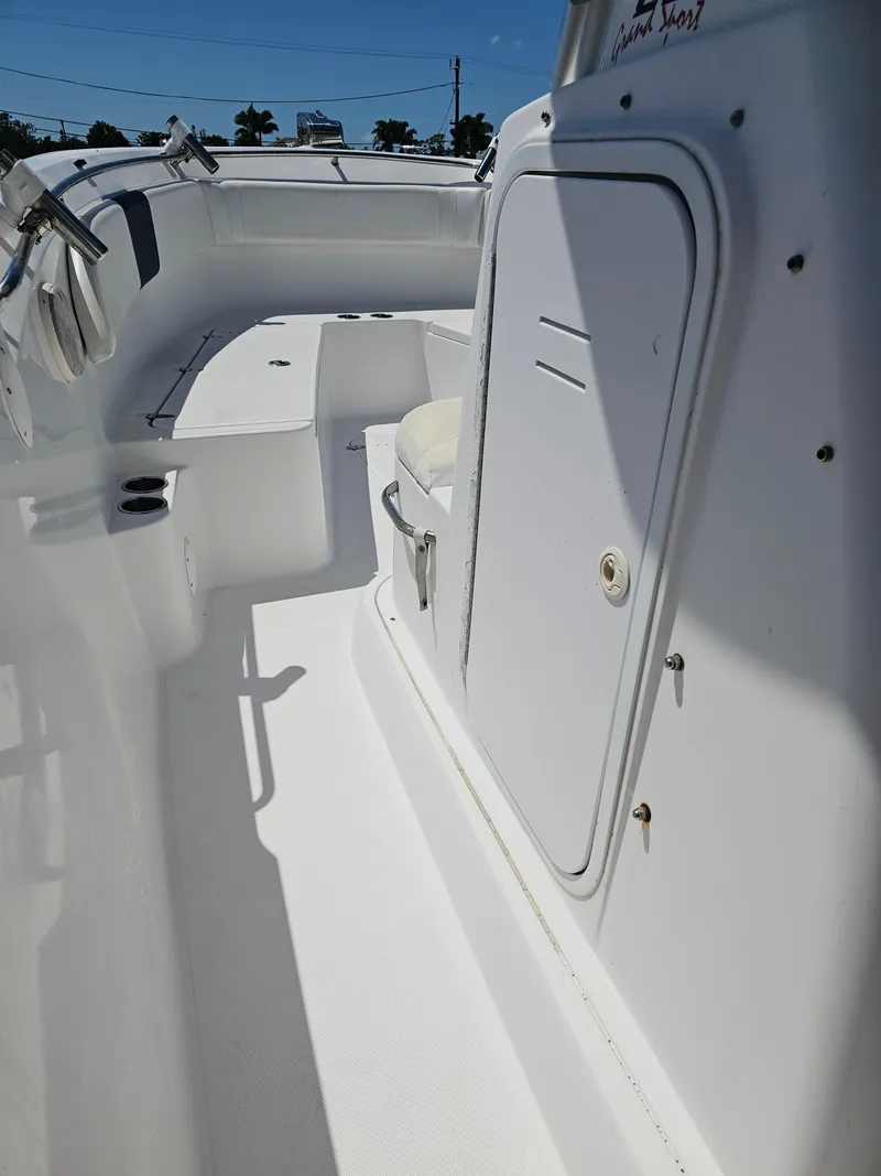 Slide: The Image of 2008 Pro-Line 29 Grande Sport boat interior, featuring white seating and storage compartments. - 39