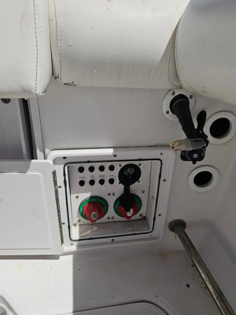 Slide: The Image of Control panel on a 2008 Pro-Line 29 Grande Sport boat, featuring switches and dials. - 48