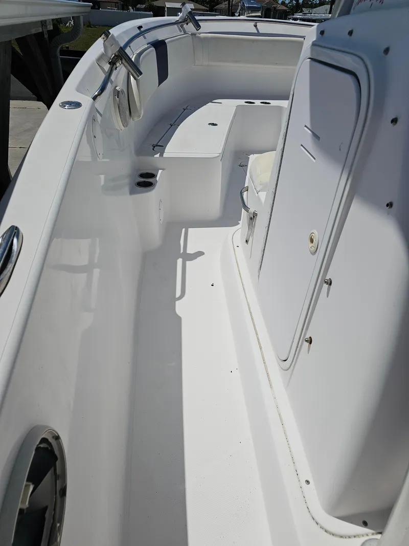 Slide: The Image of 2008 Pro-Line 29 Grande Sport boat interior, featuring white seating and storage compartments. - 9
