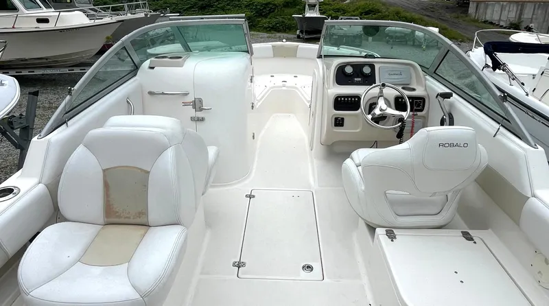 Slide: The Image of 2016 Robalo R227 Dual Console boat interior with white seating and steering console. - 10