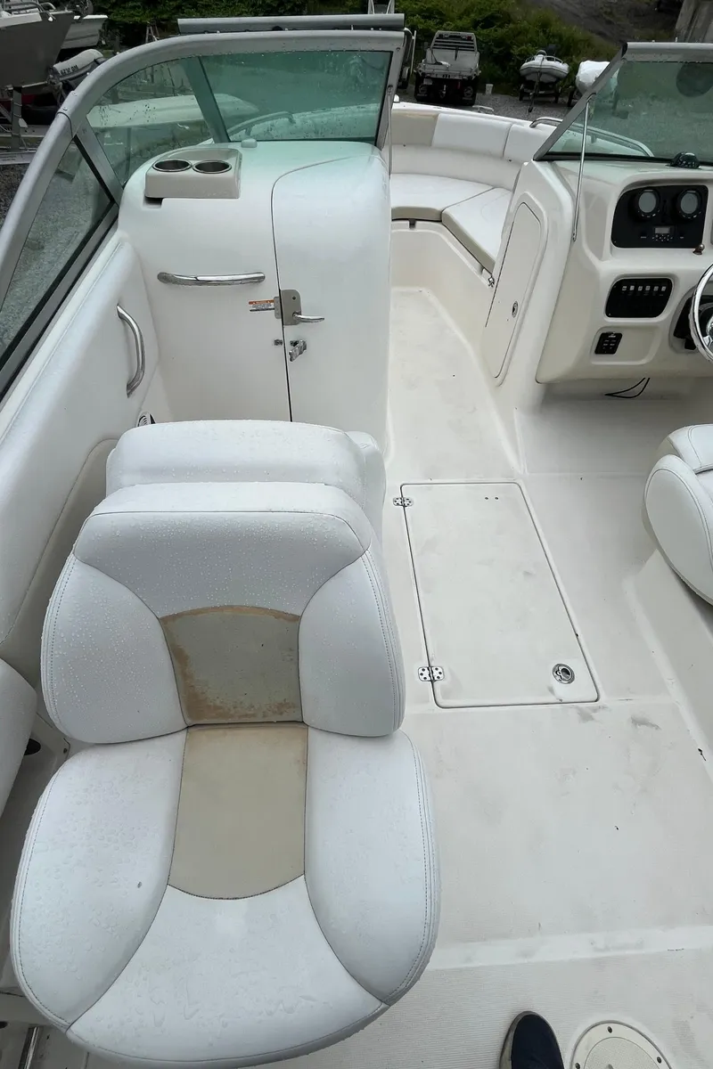Slide: The Image of 2016 Robalo R227 Dual Console boat interior with white seating and dashboard. - 13