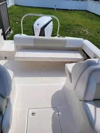 Slide: The Image of 2016 Robalo R227 Dual Console boat interior with seating and outboard motor. - 6