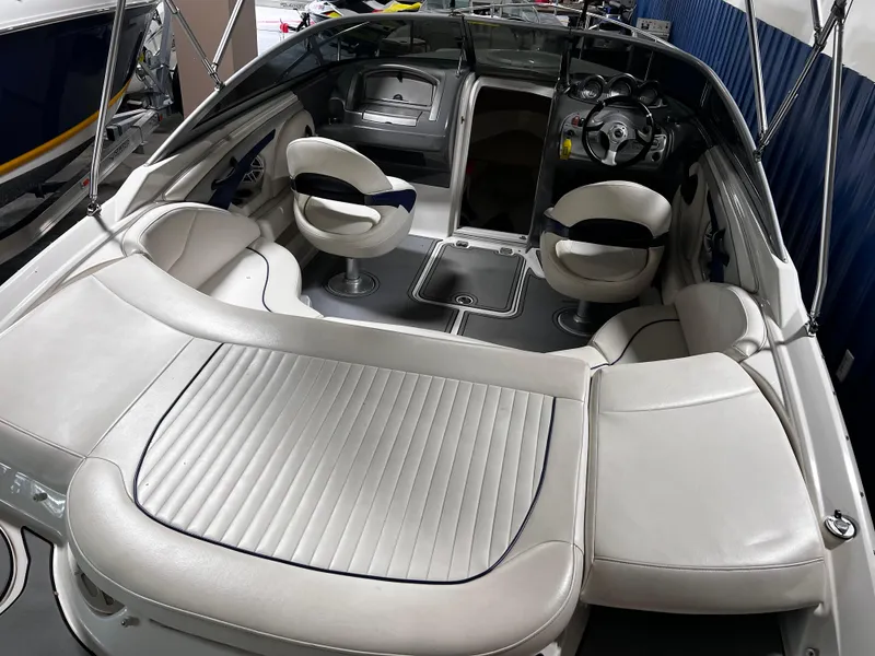 Slide: The Image of 2008 Monterey 214FSC boat interior with white seating and modern dashboard. - 2