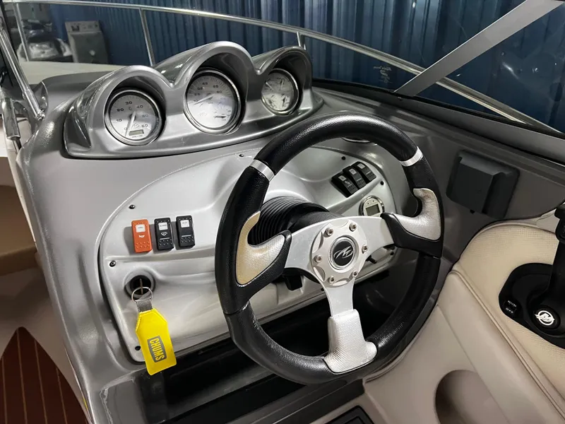 Slide: The Image of 2008 Monterey 214FSC boat dashboard with steering wheel and gauges. - 4