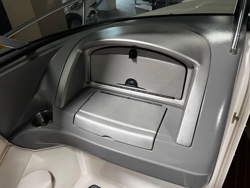 Slide: The Image of 2008 Monterey 214FSC boat dashboard with storage compartment and cup holder. - 5