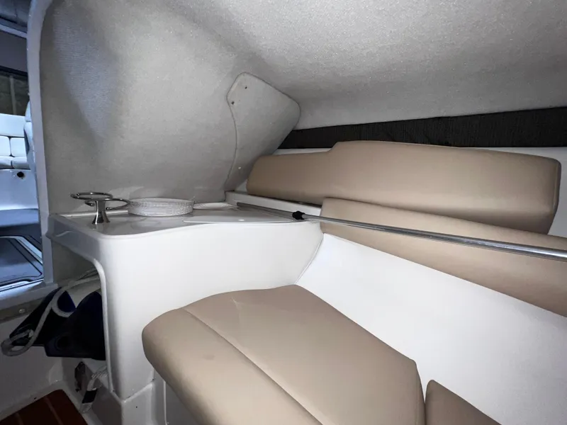 Slide: The Image of 2008 Monterey 214FSC cabin interior with beige seating and compact sink area. - 7