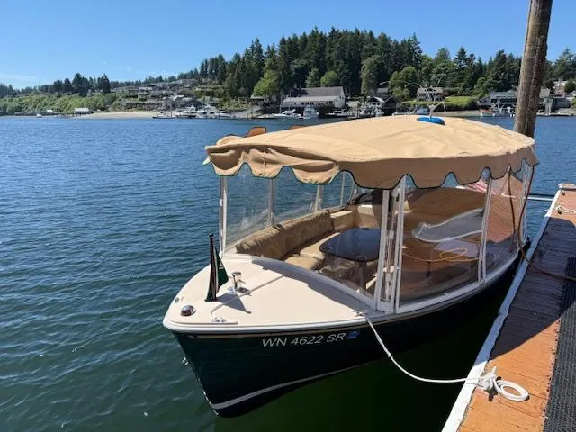 Slide: The Image of 2009 Duffy Snug Harbor boat docked on a serene lake with scenic background. - 0