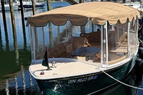 Slide: The Image of 2009 Duffy Snug Harbor boat with tan canopy docked in marina. - 1