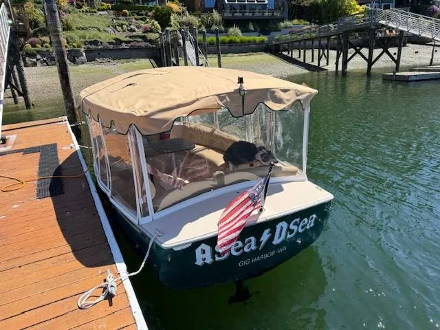 Slide: The Image of 2009 Duffy Snug Harbor boat docked with canopy and American flag. - 3