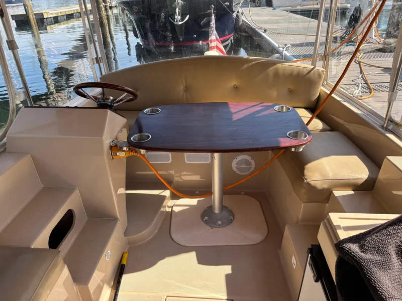 Slide: The Image of 2009 Duffy Snug Harbor boat interior with table and seating, docked at marina. - 6