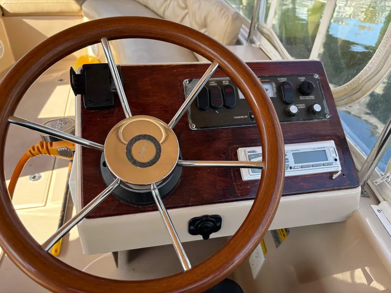 Slide: The Image of Steering wheel and control panel of a 2009 Duffy Snug Harbor boat. - 9