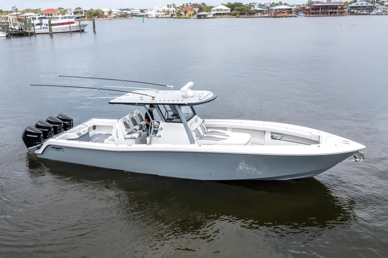 The Image of 2022 Invincible 39 Open Fisherman boat on calm water, featuring multiple outboard engines. - 0