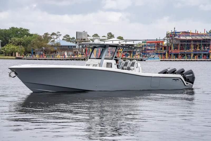 Slide: The Image of 2022 Invincible 39 Open Fisherman boat on calm water near colorful waterfront buildings. - 10