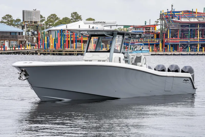 Slide: The Image of 2022 Invincible 39 Open Fisherman boat on water, featuring sleek design and multiple engines. - 11